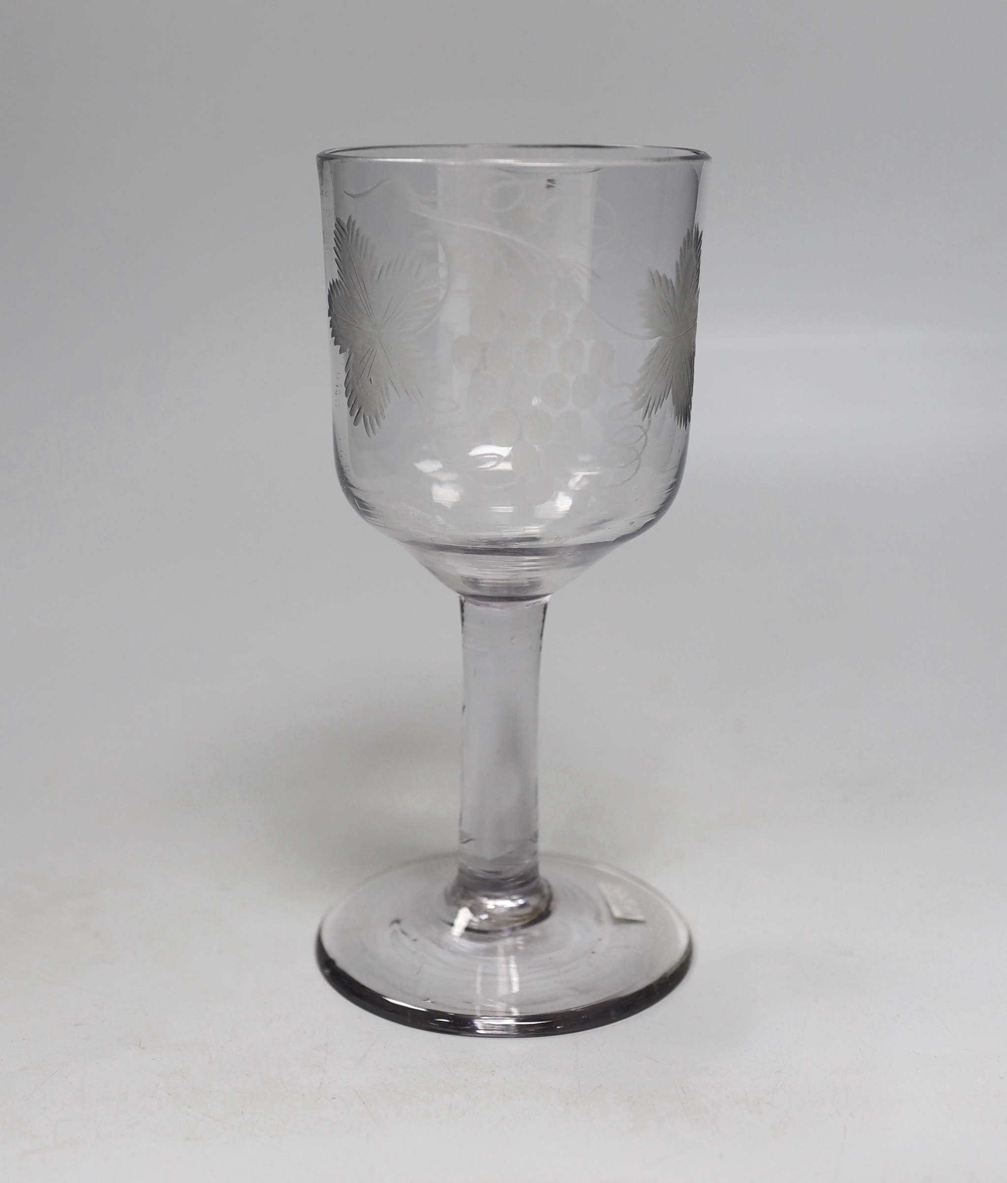 An English lead crystal goblet, c1740-50, ogee bowl with tool marks, engraved fruiting vines and a bird, with a plain stem, conical foot and rough pontil, 19.4cm